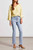 Light wash micro flare jean with exposed buttons