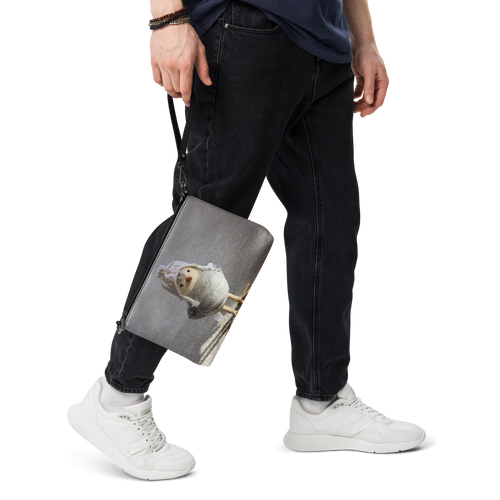 Crossbody Bag 017, Unisex All-Over Print. Black and White variations. Size 11″ × 8″ × 1.5″ (27.9 cm × 20.3 cm × 3.8 cm). Strap Drop Length: 14″to 27″ (35.56 cm to 68.58 cm). Design on Front and Back. Picture of DIY bird wrapped with grey cloth and wearing an over the ears Himalayan style cap. Very stylish gift for Family, Friends, Coworkers, Self, and Others.