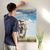 Enhanced Matte Paper Poster With Hanger 008. Oak Frame 24in x 36in (60.96cm x 91.44cm), Front View. Picture shows elephant mom and calf in short grass. Sky is blue with puffy white clouds. Great Gift for Family, Friends, Coworkers, Self, and Others.