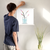 Enhanced Matte Paper Poster With Hanger 011. White Frame 18in x 18in (45.72cm x 45.72cm), Front View. Picture shows drawing of water in glass vase with branches sprouting colorful pink and yellow flower buds. Great Gift for Family, Friends, Coworkers, Self, and Others.