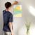Enhanced Matte Paper Poster With Hanger 016. White Frame 12in x 18in (30.48cm x 45.72cm), Front View. Picture shows boho style drawing representing a sunset over hill-like shapes of green, blue, and orange. Great Gift for Family, Friends, Coworkers, Self, and Others.