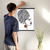 Enhanced Matte Paper Poster With Hanger 018. Black Frame, 18in x 24in (45.72cm x 60.96cm), Front View. Picture shows boho design art drawing of lady of with hair wrapped, red lipstick, and large hanging earrings. Great Gift for Family, Friends, Coworkers, Self, and Others.