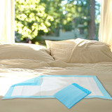 Disposable Underpads on a bed.