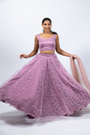 Ethereal. This elegant lehenga set is embellished with all over inticate floal embroidery. Paired with sleeveless blouse and a soft net dupatta. Comes with attachable sleeves. This lehenga set is available in three sizes: small, medium, and large. Refer to our size guide for more details. Our skirts are stitched to fit sizes S-L through adjustable tie or elastic at the back. Please refer to the size guide.