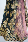 Regal lehega set in deep emerald green with heavy embroidery all over. Comes with a dusty pink dupatta. Fits XS-S. Please refer to the size guide.