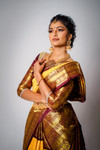 Straight from the 'City of Thousand Temples' - Kanchipuram, this saree is a fusion of geometric design in the body and traditional korvai border executed to perfection. The border design is inspired by 'Chakras' and animal sculptures from the temples in Kanchipuram. We love this rare combination of Yellow - deep Wine color, which almost looks like dark chocolate. This comes with a beautiful hand embroided blouse.
