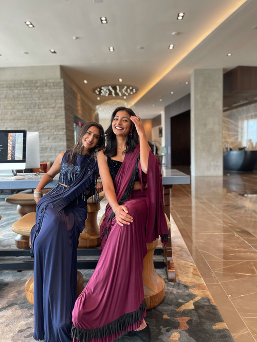 Designer pre-pleated pure satin saree. Chic and comfortable saree that you can wear in under a minute. Yes, thats right! Wrap around like a skirt, secure it and you are good to go. Frills are an added feature you will love! Comes with a designer blouse that can be used as a crop top with other outfits too.