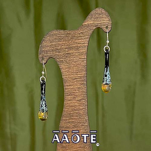 The golden yellow, sunshine bulb on the base of each of these sweet, delicate glass drops catches the light just right.