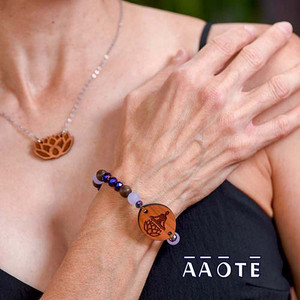 Our beautifully crafted wooden diffuser focals finished with shimmer and shine to bring colorful life to their already lovely functionality. Enjoy them by applying a few drops of essential oil to the engraved wood focal so as to enjoy aromatherapy all day long.
The wood focals are made in our shop in Pennsylvania, USA, and are sourced from sustainably grown American hardwood. The engraved image derives from AAOTE's Tari Zarka's artwork. Variations in the wood's grain and color are natural distinctions making each piece unique.