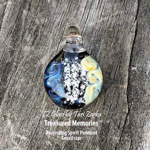 These memorial necklaces allow you to encapsulate the precious memories of that special person or pet in your life that has passed away. Each is a sentimental and meaningful work of art that can be worn for years and passed down for generations.
Tari works with love to encase and forever preserve the ashes that you provide into durable borosilicate glass, creating a timeless treasure. Each pendant is hand-crafted and will have its own unique look. These memorial necklaces allow you to encapsulate the precious memories of that special person or pet in your life that has passed away. Each is a sentimental and meaningful work of art that can be worn for years and passed down for generations.
Tari works with love to encase and forever preserve the ashes that you provide into durable borosilicate glass, creating a timeless treasure. Each pendant is hand-crafted and will have its own unique look.