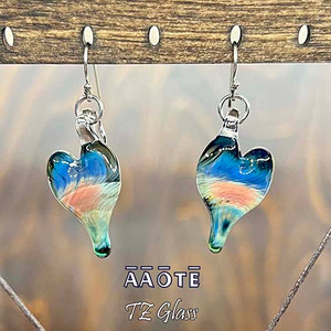 It's up to ourselves to protect our light so we may best lead with love. Created to empower our shields to best protect our love-lifter drive, which can often be hindered by the state of our world. Each and every heart is individually flameworked glass created by AAOTE's founder, Tari Zarka, a life-long creative, maker, and love-lifter.
The hearts are each being about 1" tall. These are handmade flamework glass. Please expect unique variation in each and every one created. It's up to ourselves to protect our light so we may best lead with love. Created to empower our shields to best protect our love-lifter drive, which can often be hindered by the state of our world. Each and every heart is individually flameworked glass created by AAOTE's founder, Tari Zarka, a life-long creative, maker, and love-lifter.
The hearts are each being about 1" tall. These are handmade flamework glass. Please expect unique variation in each and every one created.