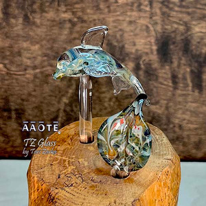 Flameworked glass art sculpture by AAOTE's founder, Tari Zarka. Totally one-of-a-kind, investment-quality glass art on a wooden base.
This baby Dolphin features a whilring skies with dichroic glass design inside the body with a leaf accent. It's a 3-piece set including the wood base. The overall size is approximately 5.55"H x 3.5"W x 3"D.
There is only one available. The piece you see is the piece you get. It will arrive dissassebled. The glass pieces slide out of the base, and get wrapped separate from the base for safe shipment. Assembly is as easy as sliding the glass rods into the wooden base.
The wooden base is actually crafted from fallen timber from AAOTE's property.
This sculpture will ship USPS Priority with insurance and is not eligible for free shipping offers. Flameworked glass art sculpture by AAOTE's founder, Tari Zarka. Totally one-of-a-kind, investment-quality glass art on a wooden base.
This baby Dolphin features a whilring skies with dichroic glass design inside the body with a leaf accent. It's a 3-piece set including the wood base. The overall size is approximately 5.55"H x 3.5"W x 3"D.
There is only one available. The piece you see is the piece you get. It will arrive dissassebled. The glass pieces slide out of the base, and get wrapped separate from the base for safe shipment. Assembly is as easy as sliding the glass rods into the wooden base.
The wooden base is actually crafted from fallen timber from AAOTE's property.
This sculpture will ship USPS Priority with insurance and is not eligible for free shipping offers.
