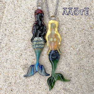 Sculptural wearable glass art by AAOTE's founder, Tari Zarka. Each flameworked glass mermaid is individually hand-made to-order and will take up to 6 days to produce. Each will embody its own uniquenesses and beauty as they are created from molten glass without molds; all skilled handwork by a glass artist.
Mermaids measure around 3" to 3.25" but you can request yours to be as small as possible (can be shrunk to approximately 2.25" tall). It's not less expensive to have it made smaller. Sculptural wearable glass art by AAOTE's founder, Tari Zarka. Each flameworked glass mermaid is individually hand-made to-order and will take up to 6 days to produce. Each will embody its own uniquenesses and beauty as they are created from molten glass without molds; all skilled handwork by a glass artist.
Mermaids measure around 3" to 3.25" but you can request yours to be as small as possible (can be shrunk to approximately 2.25" tall). It's not less expensive to have it made smaller.