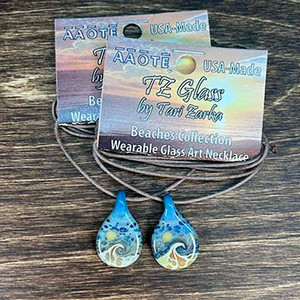 Created from raw glass material, a wearable glass art painting of a wave and a sun, or a moon, depending on what one chooses to see. Made with love to be year-round reminders of vacation vibes. A unique gift for one who loves the beach!