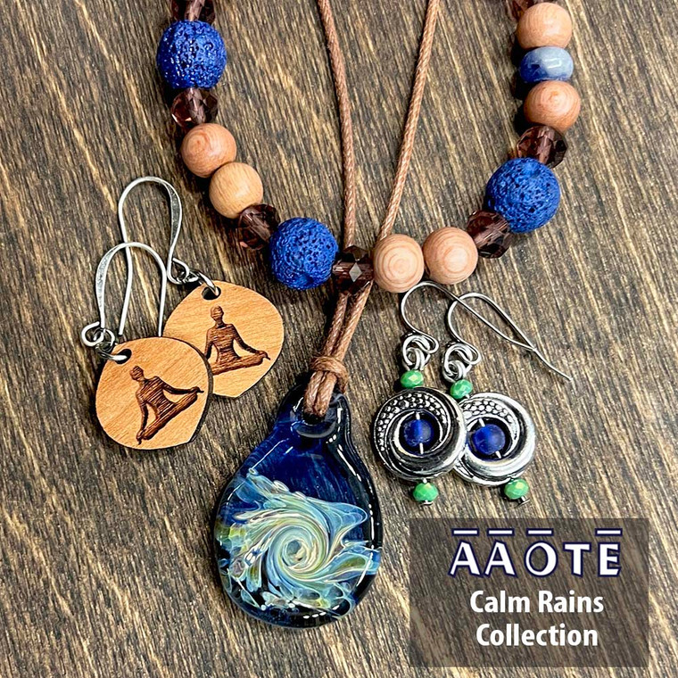 Our Calm Rains Collection features some calming blues and earthy, rich browns. 

Comprised of our Royal Lava Diffuser Beaded Stretch Aromatherapy Bracelet, Full Circle Metal Earrings in Tides, Wood Diffuser Aromatherapy Earrings in the Meditate design, and a TZ Glass Fidget Widget Mindfulness Tool Necklace in Rain. Choose just one or go for the whole collection. They look great together!