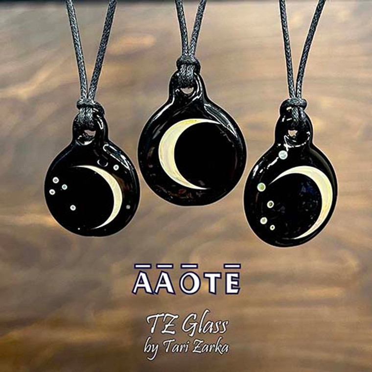 Wearable glass art paintings of the moon in glass. These are double-sided moon pendants by AAOTE's founder, Tari Zarka. A lifelong artist, lover of glass art, and nature.

The Crescent Moon is on one side, choose between the 'with Stars' or 'without Stars' design options.