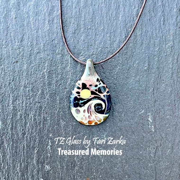 Tiny Beaches has evolved to now be available as a Treasured Memories cremains glass piece. In this renowned design I hide the ashes so only those in-the-know, know (they are within the layers of glass representing the water and wave).

Tiny Beaches glass art necklaces are created to help keep close healing water vibes, all year-long.

Tiny Beaches pendant finished just under 1" tall.