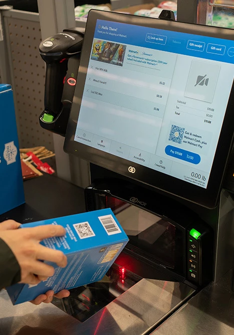 A 2D barcode on a product being scanned at a retail checkout