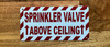 sprinkler-valve-above-ceiling-white-safety-sign.jpg