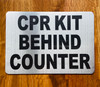 cpr-kit-behing-counter-5-x-7-self-adhesive-metal-sign.jpg