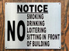 NO SMOKING DRINKING LOITERING SITTING IN FRONT OF BUILDING HPD SIGN