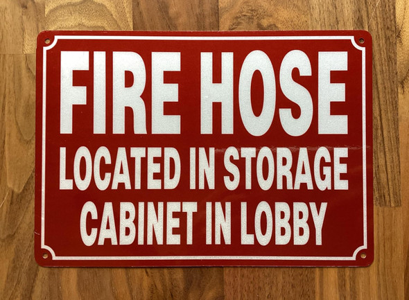 NYC FIRE HOSE LOCATED IN STORAGE CABINET IN LOBBY SIGN
