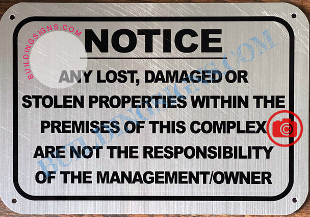 NOTICE ANY LOST DAMAGED OR STOLEN PROPERTIES WITHIN THE PREMISES OF THIS COMPLEX ARE NOT THE RESPONSIBILITY OF THE MANAGEMENT OR OWNER SIGN- BRUSHED ALUMINUM
