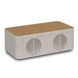 A wireless charger with a textured cork top and a light-coloured, speckled body, featuring dual speakers.