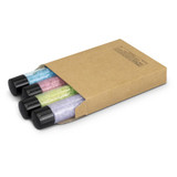 A set of three bath salt tubes in pastel colours, packaged in a brown kraft box. Each tube has a black cap.