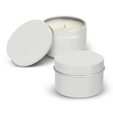 A set of two silver travel candles in metal tins, one with an open lid revealing a cream-coloured wax.