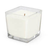 A square glass candle holder containing a white scented candle with a single wick.