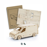 A wooden model van in natural colour, alongside assembly instructions and pre-cut parts for assembly.