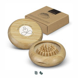 A bamboo brush and mirror set in a circular case, accompanied by a cardboard box. The brush features wooden bristles.