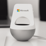 A silver and white wireless speaker with a rounded base and a logo on the front.