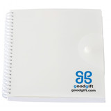A white spiral notepad with a transparent cover and a logo on the lower right corner.