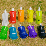 A collection of ten 500ml water pouches in various colours, each featuring a spout and some with logos.