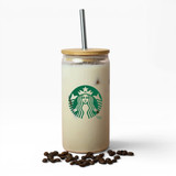 A drink bottle with a bamboo lid and metal straw, featuring a logo and filled with a creamy beverage, placed on coffee beans.