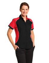 A woman models a women's button-up shirt featuring a black base with red contrast panels and a logo.