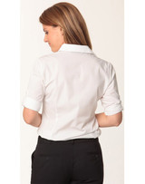 A white 3/4 sleeve button-up shirt for women, featuring rolled sleeves and a classic collar. It includes branding on the shirt.