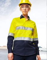 A long-sleeve safety shirt in bright yellow and navy, featuring reflective tape and a logo, worn by a model in a hard hat.