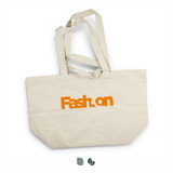 A large beige tote bag with orange branding and two sturdy handles. Features a logo on one side.