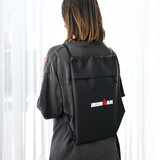A black drawstring bag with a logo, worn on the back of a person, featuring a sleek design.