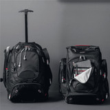 A black wheeled backpack with a retractable handle, featuring multiple compartments and zippers.