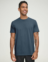 A navy blue men's premium cotton short sleeve t-shirt displayed on a smiling male model, featuring a logo.