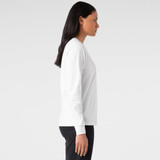A long-sleeved white t-shirt displayed on a model from the side, featuring a subtle logo.