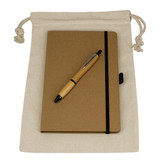 A drawstring bag in cream contains a brown journal book and a wooden pen. The set is neatly arranged for display.