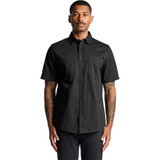 A black short-sleeved work shirt featuring a button-up front and two chest pockets. The shirt has a logo.