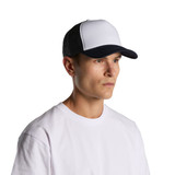 A two-tone black and white trucker cap featuring a mesh back and a solid front panel. Includes a logo.