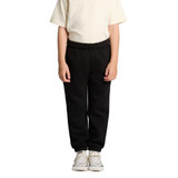 Black youth track pants with elastic waistband, paired with a light-coloured t-shirt and white sneakers.