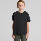 A youth heavy faded tee in black, displayed on a model against a plain background. The shirt features a logo.